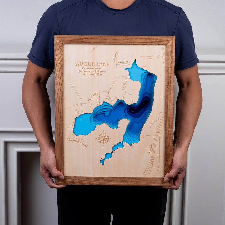 Person holding a 3D Wooden Augur Lake Map, showcasing intricate topographic details, perfect for wall art by Moc Tho