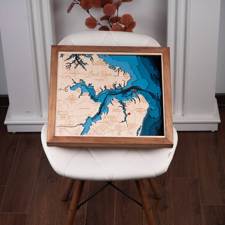 Intricate Back River 3D Wooden Nautical Map, a Moc Tho masterpiece on a white chair