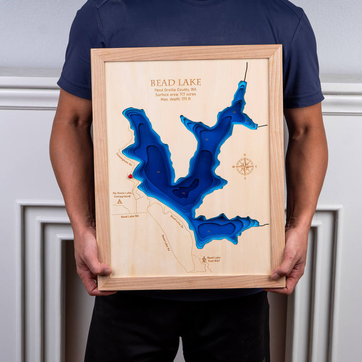 Person holding a 3D Wooden Bead Lake Map, highlighting the lake’s topography, available from Moc Tho