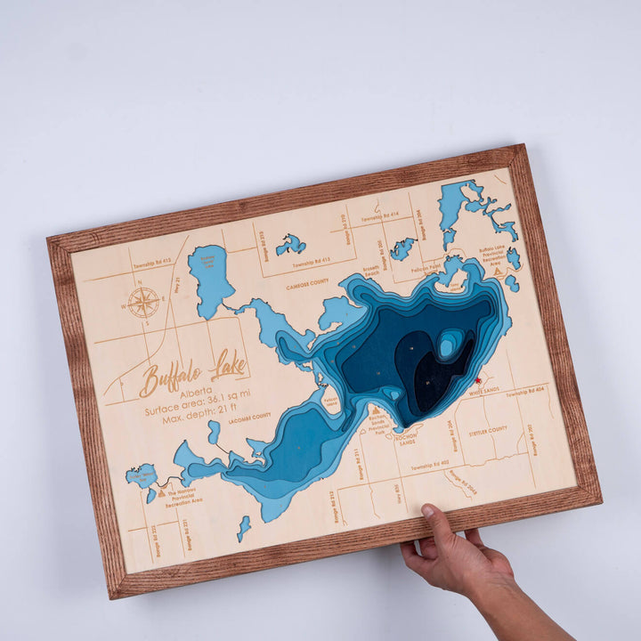 Hand holding a 3D Wooden Buffalo Lake Map with intricate topographic details, by Moc Tho